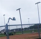 larry in a cherry picker fixin stadium lights