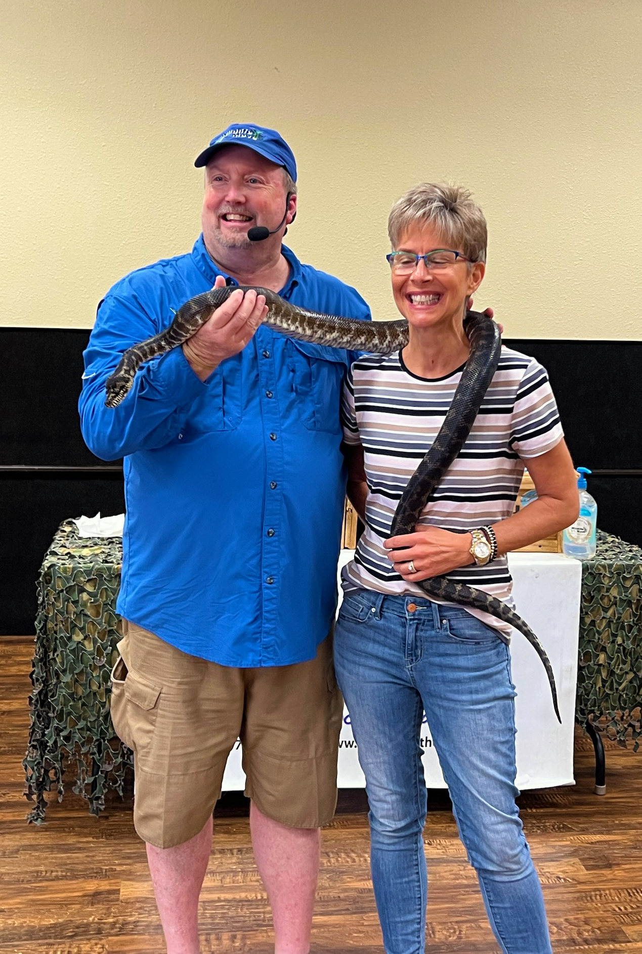 Presenter and woman with snake around her neck